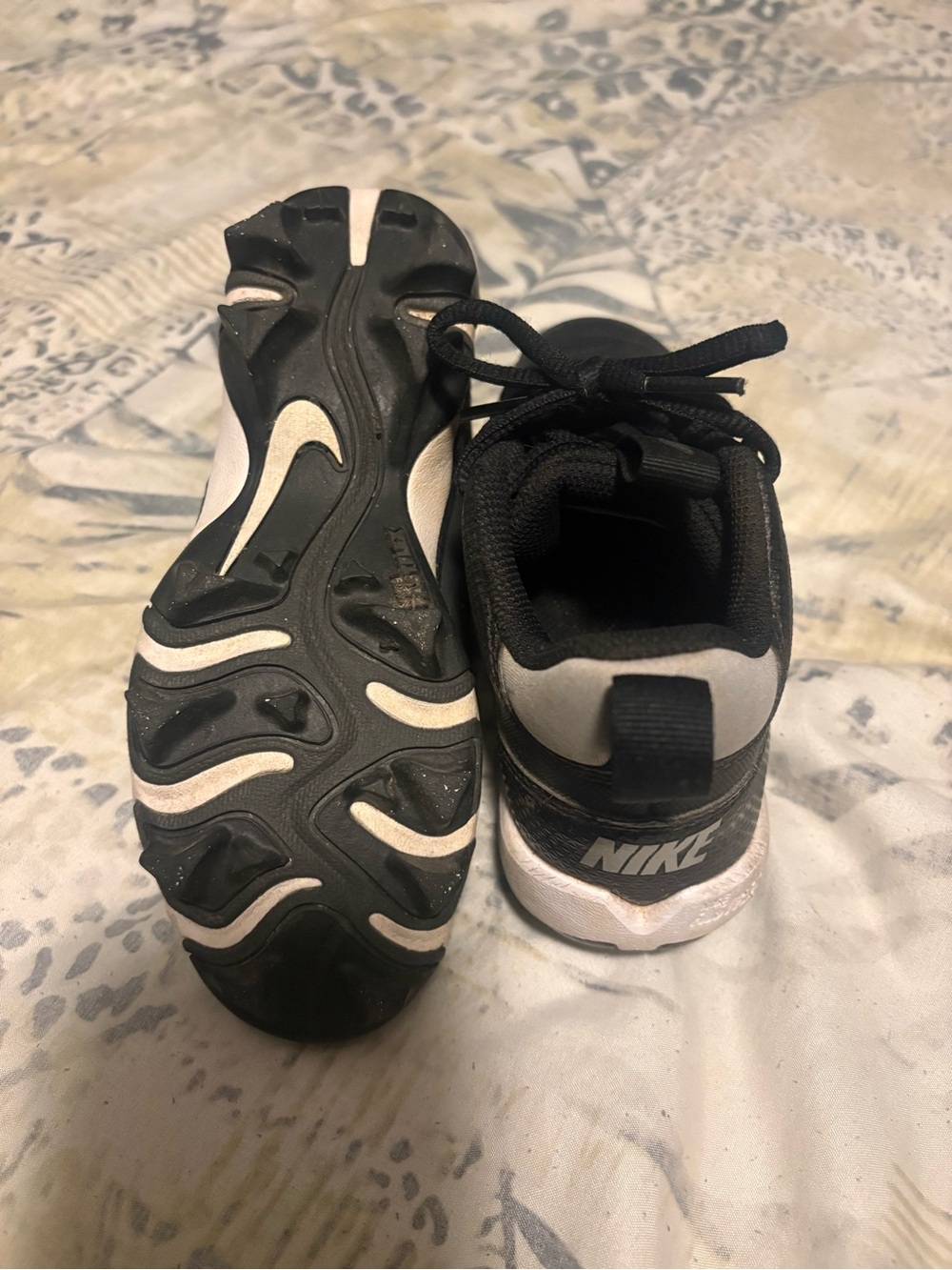 Nike Kids Black and White cleats with Lace-Up Closure